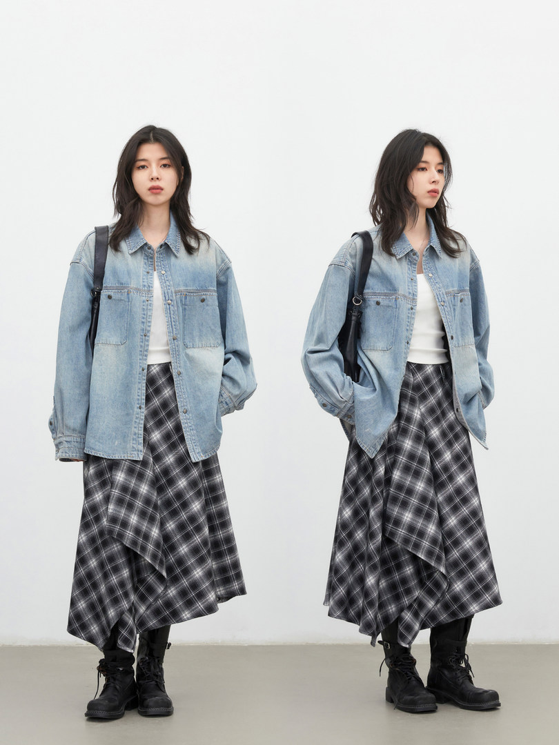 Woman wearing a light blue denim jacket with a black plaid skirt and black boots