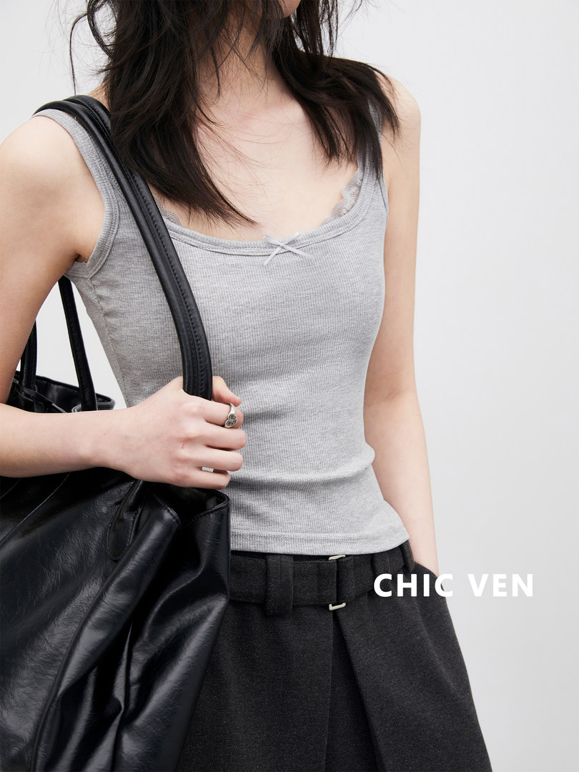 Model wearing a gray ribbed camisole top with a black shoulder bag