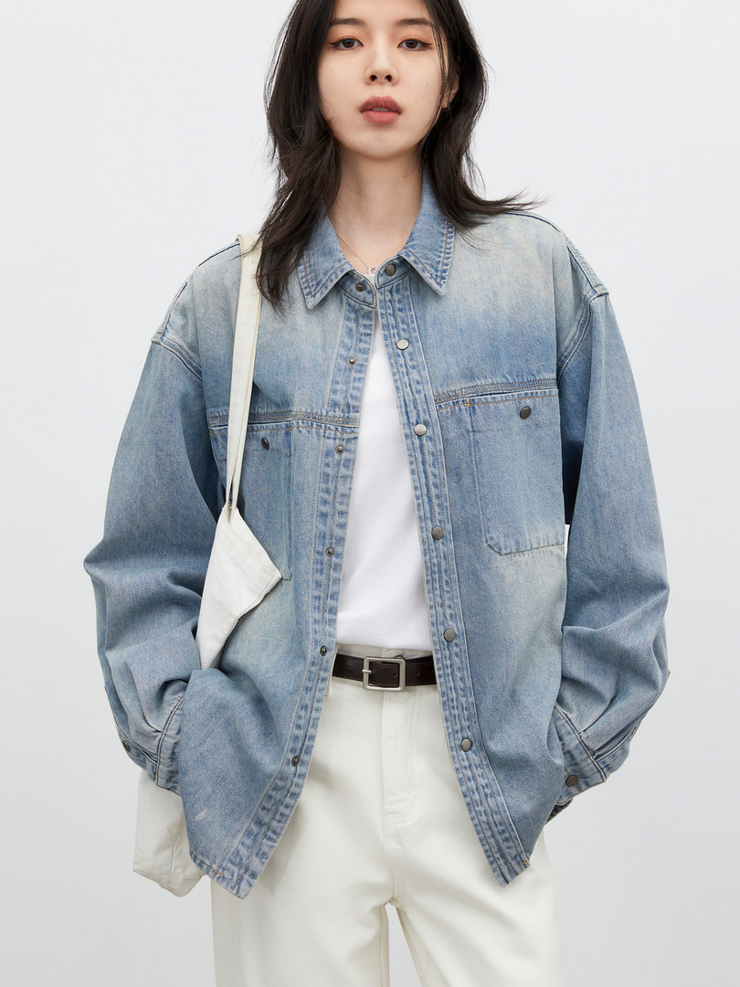 Model wearing a light blue denim jacket with white pants