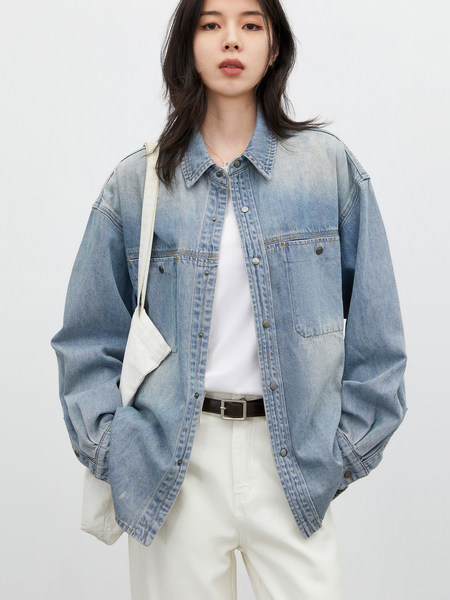 Model wearing a light blue denim jacket with white pants