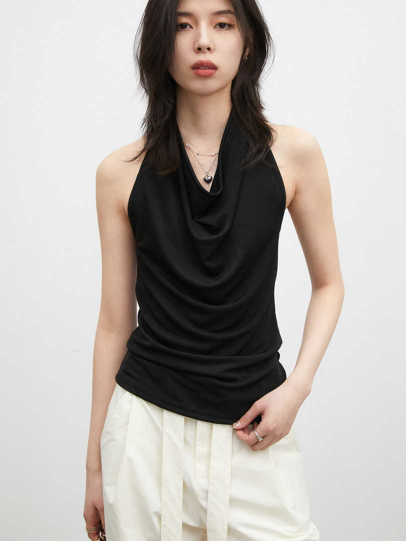 Black draped halter top worn by a model