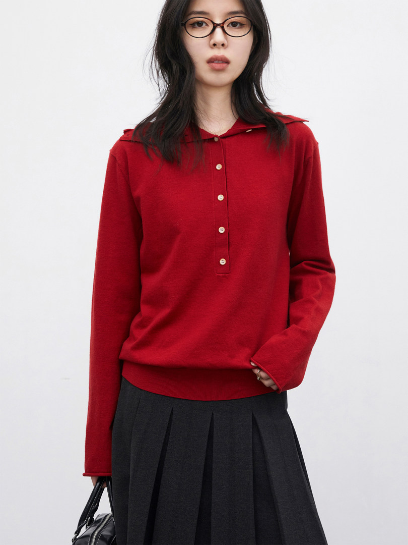 Red long-sleeve buttoned knit top worn by a model