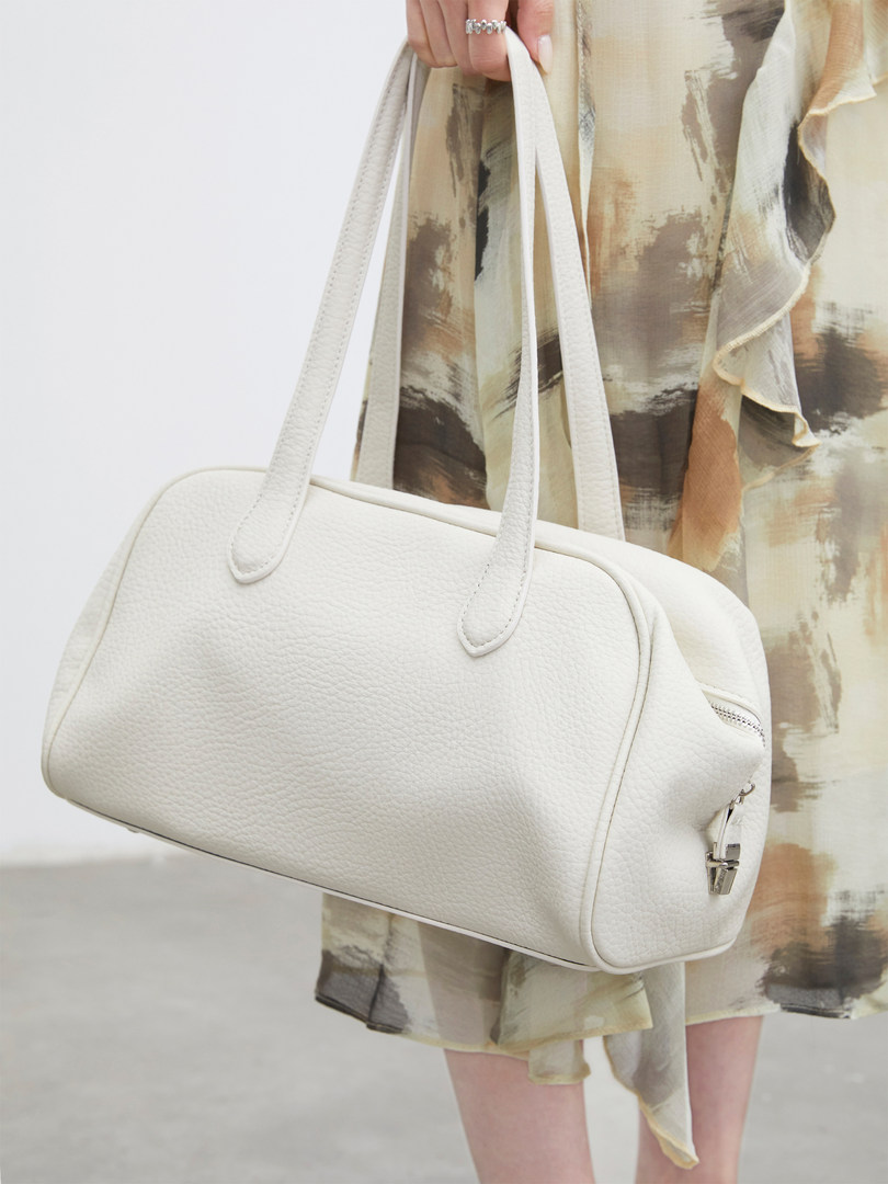 White leather shoulder bag carried by a model