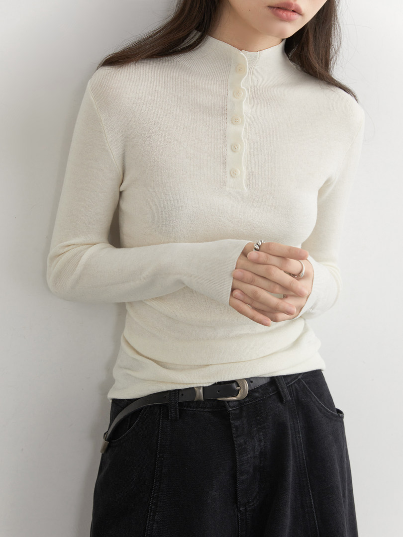 Cream long-sleeve button-front knit top worn by a model