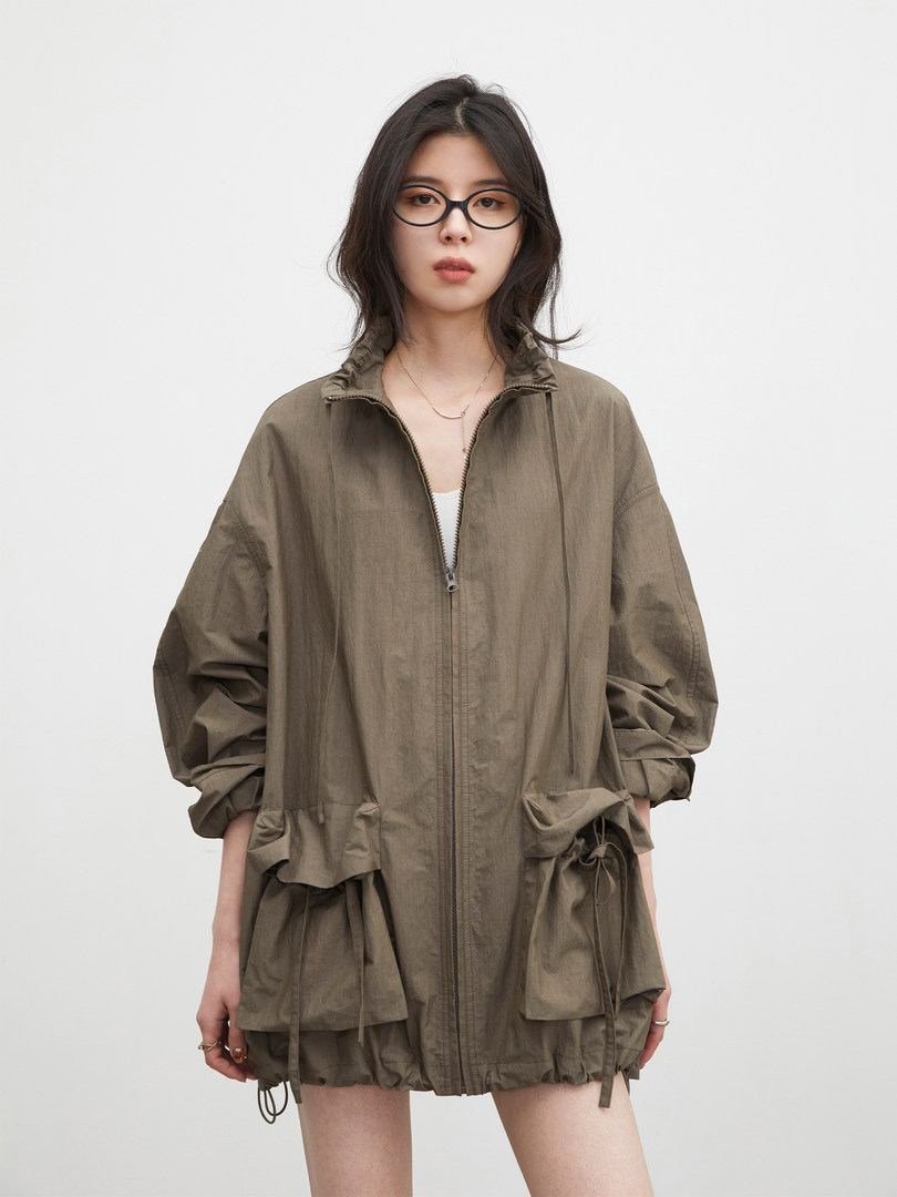 Model wearing an olive zip-up lightweight jacket