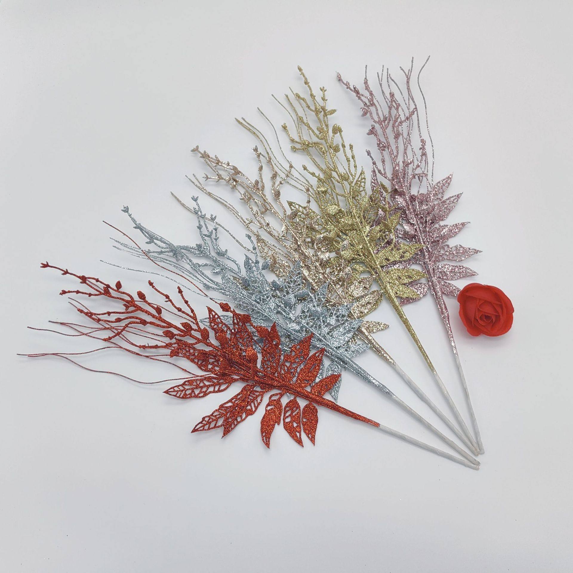 Christmas decoration with fake flowers, red fruits, gold po