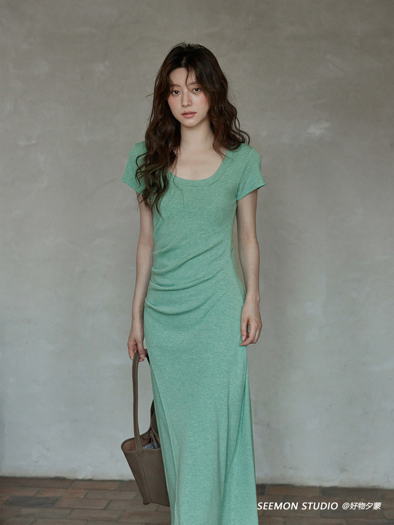 Model wearing a mint green short-sleeve maxi dress