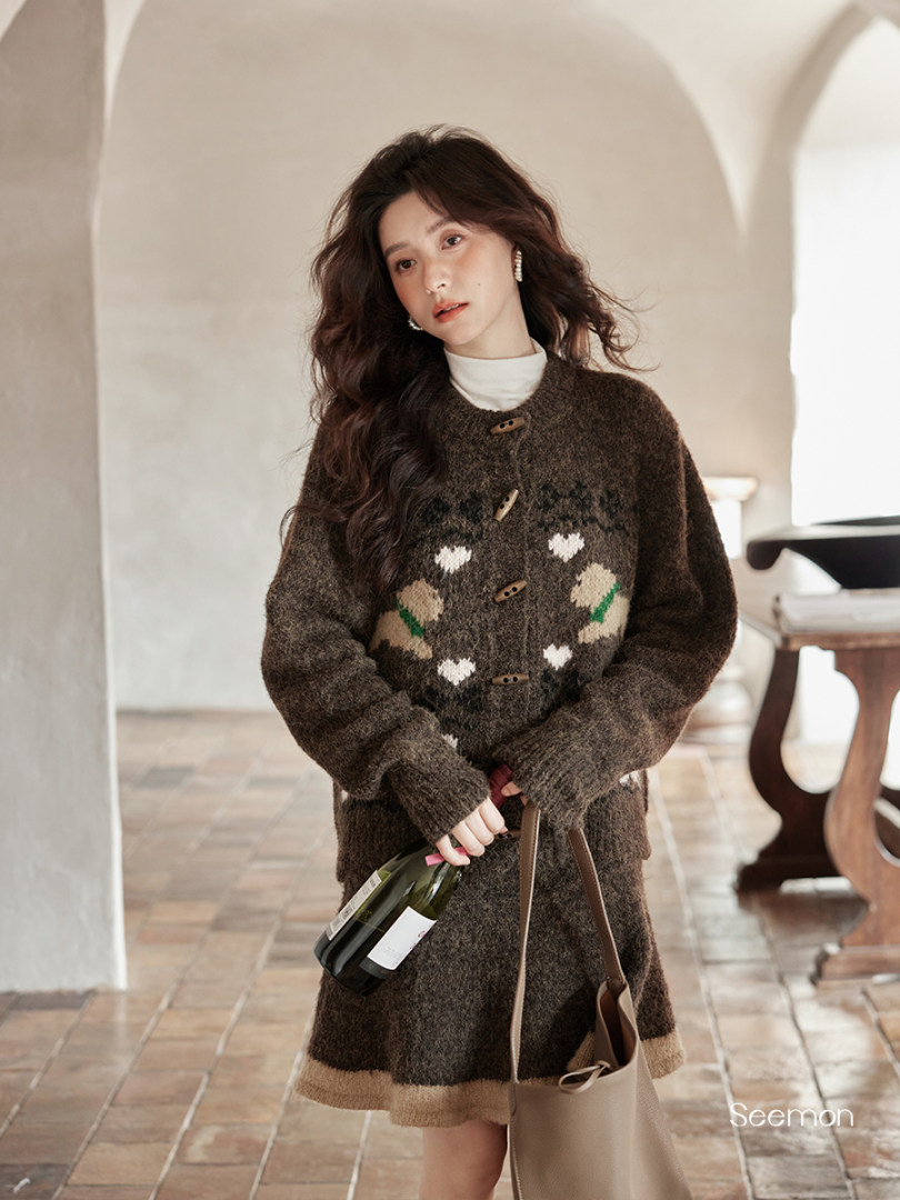 Woman wearing a brown patterned knit cardigan sweater dress