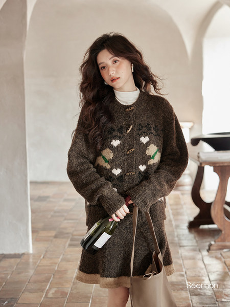 Woman wearing a brown patterned knit cardigan sweater dress