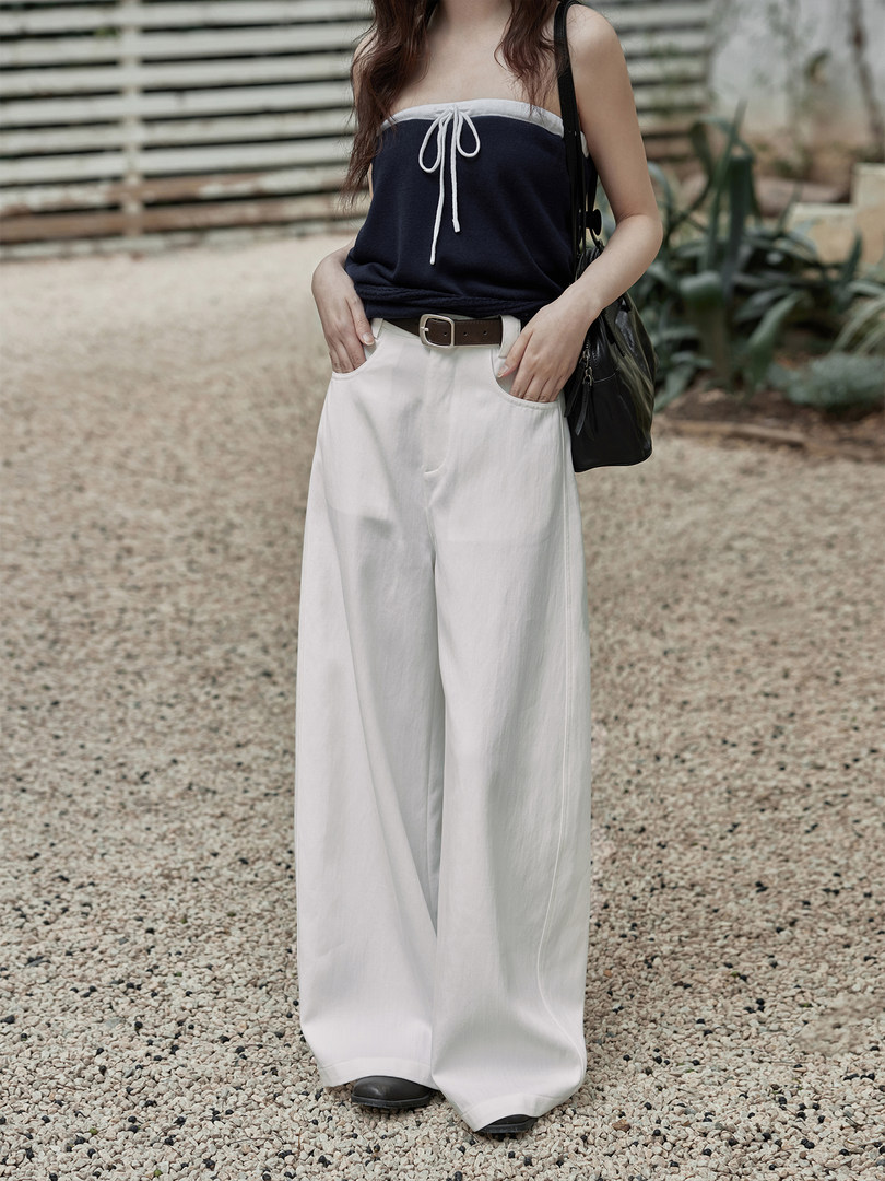 Model wearing a navy tube top and white wide-leg pants