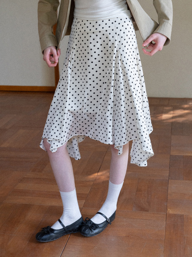 Polka dot skirt outfit with black flats worn by a model