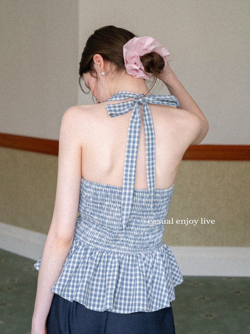 Backless blue gingham halter top worn by a model