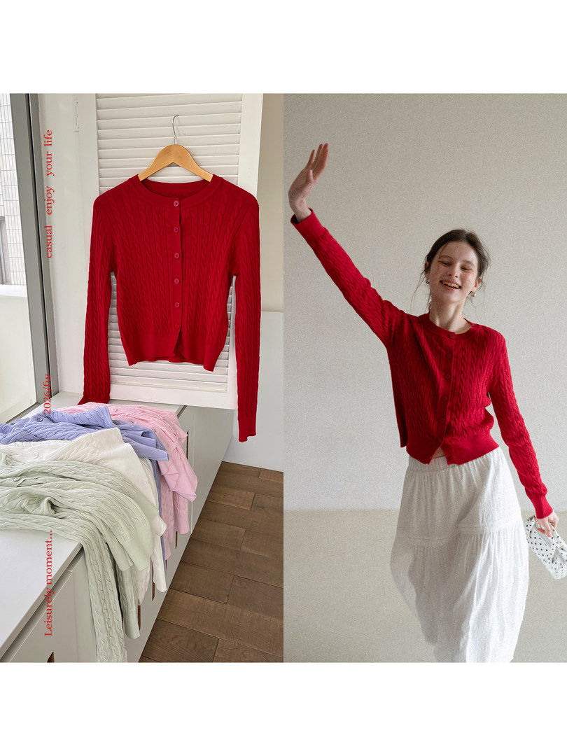 Red cable-knit button-up cardigan shown on a hanger and worn by a model