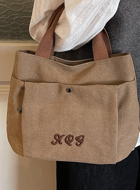 今年流行简约手拎帆布包女2026新款休闲百搭时尚大容量通勤水桶包