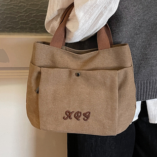 今年流行简约手拎帆布包女2026新款休闲百搭时尚大容量通勤水桶包