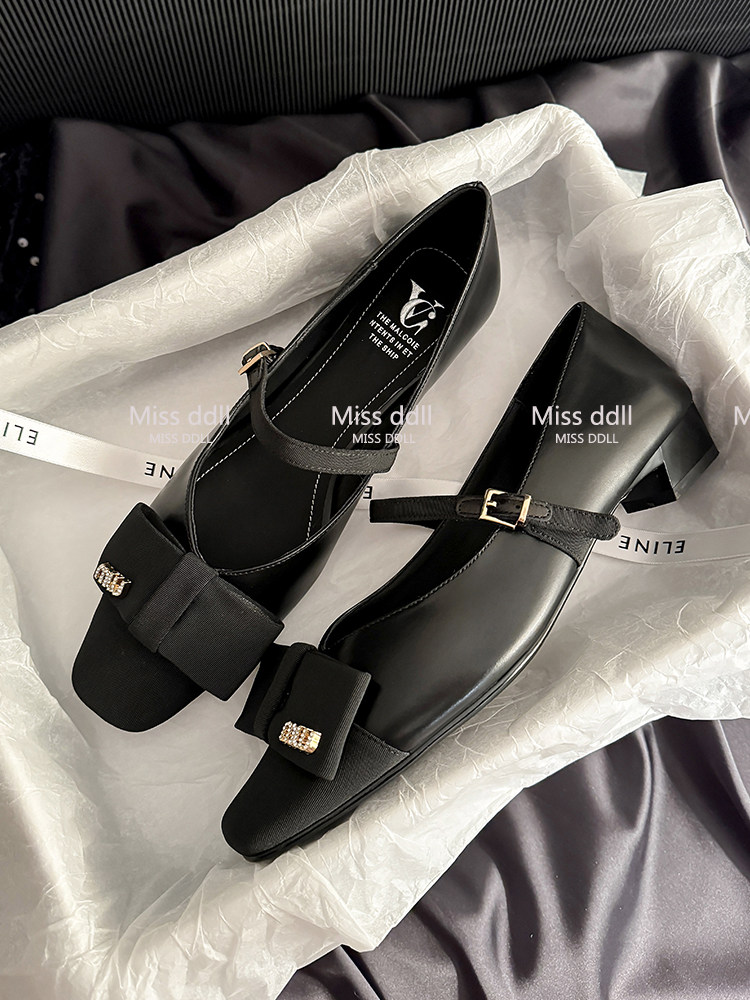 Black dress shoes with bow detail and ankle strap