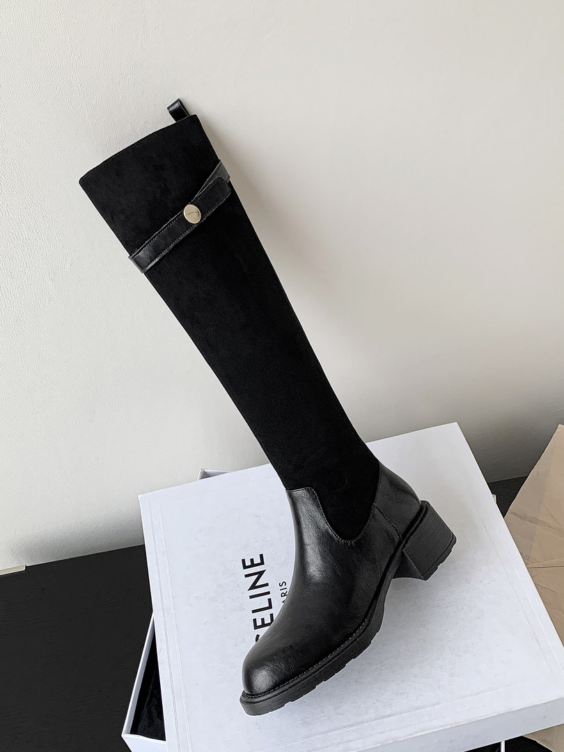 Black knee-high leather boot with chunky heel displayed on a box