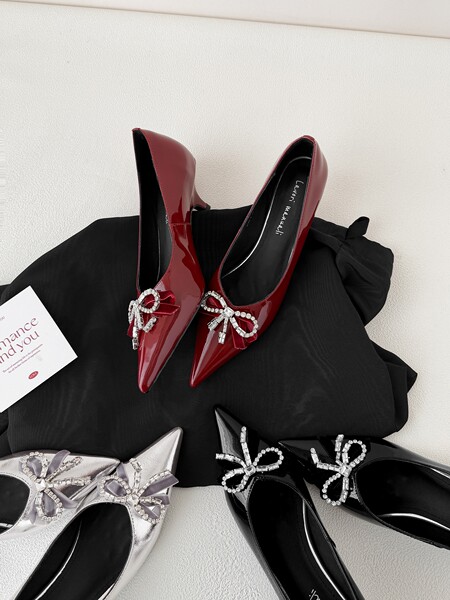 Patent leather pointed-toe heels with jeweled bow embellishments in multiple colors