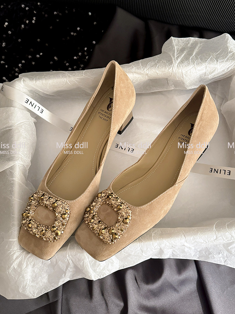 Beige embellished women’s heeled pumps on white tissue paper
