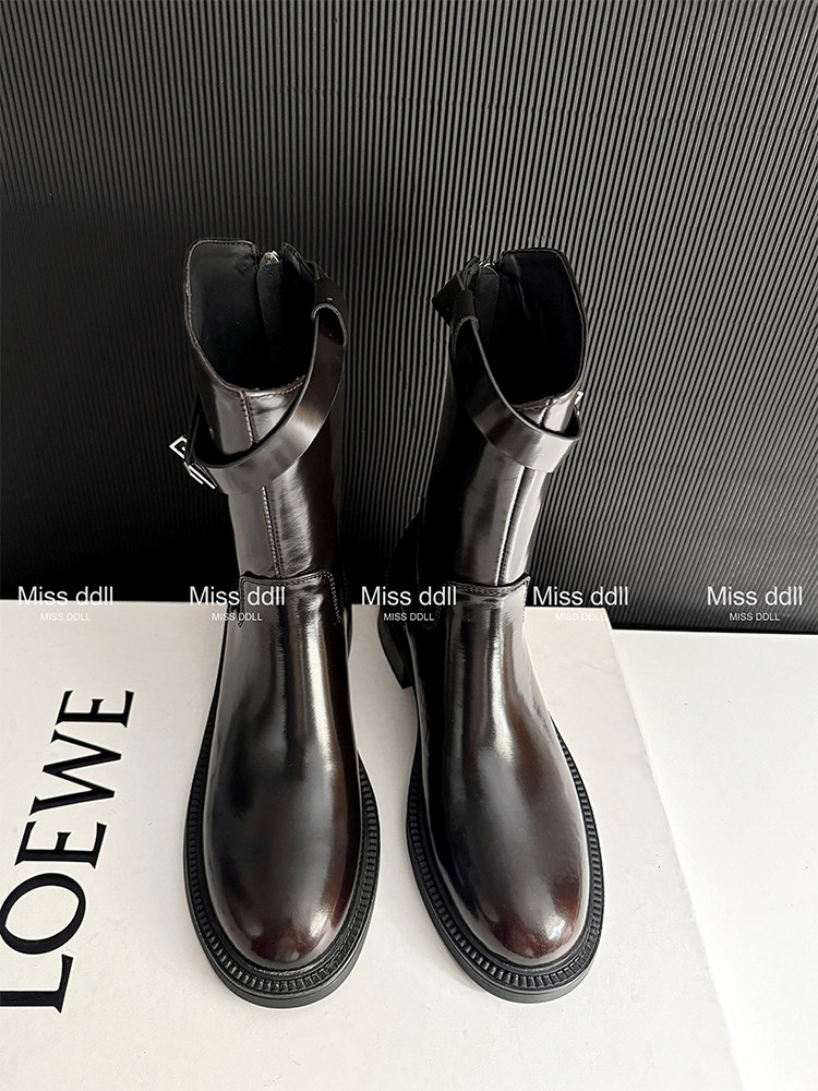 Pair of black leather ankle boots displayed on a surface