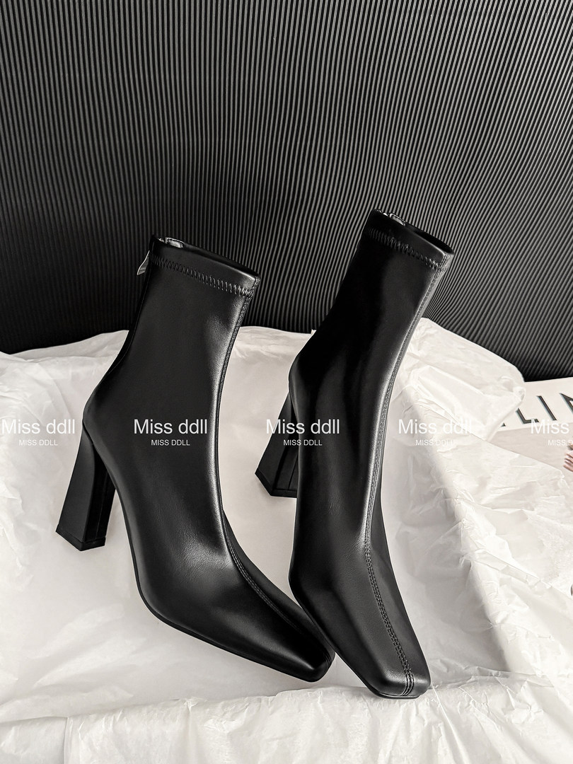 Pair of black pointed-toe ankle boots with block heels