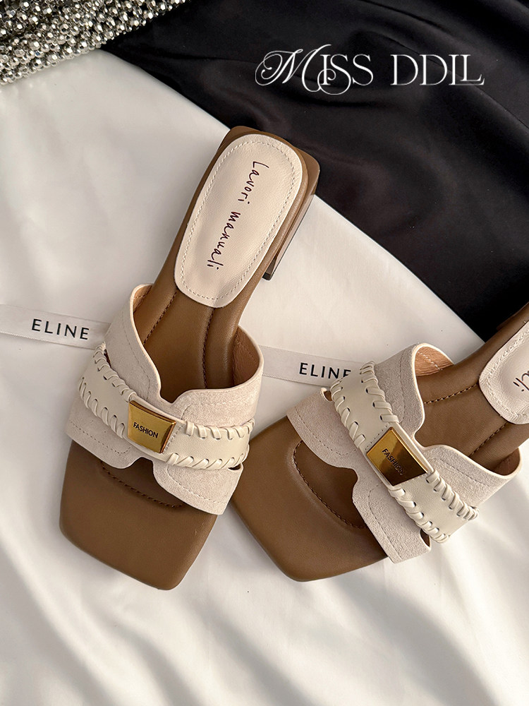 Pair of beige and brown slide sandals with braided strap detail