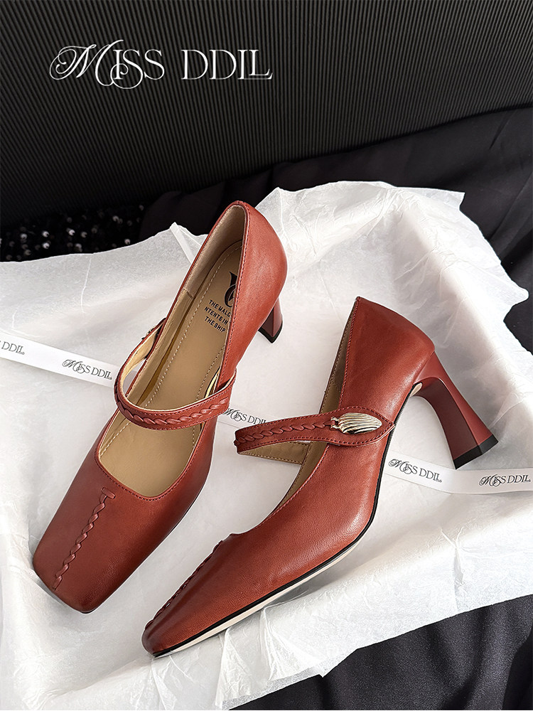 Red leather heeled pumps displayed on tissue paper