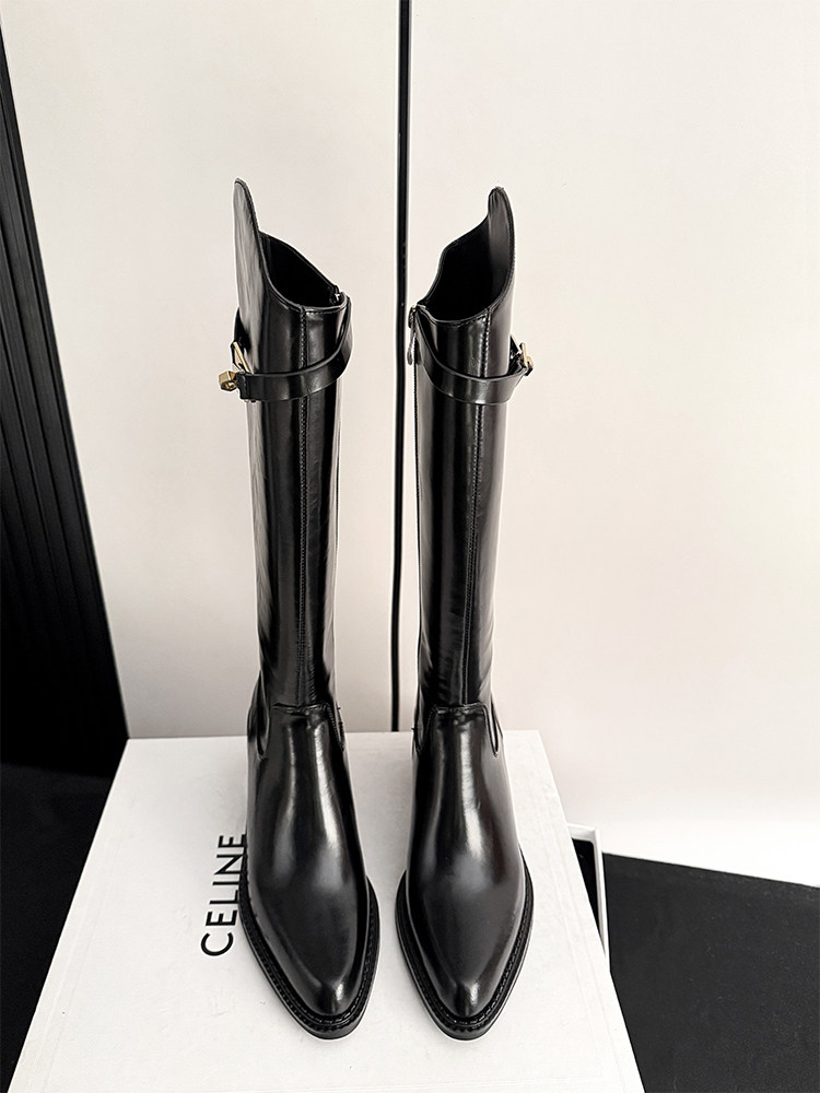 Black knee-high leather boots displayed on a box