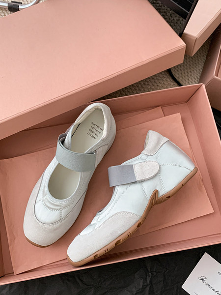 White Mary Jane-style flats in a pink shoebox