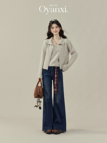 Model wearing a beige knit cardigan and top with wide-leg jeans