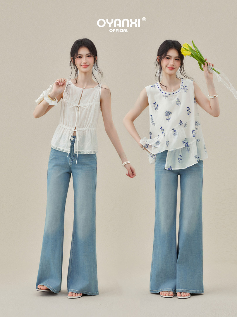 Two models wearing sleeveless floral tops with wide-leg light blue jeans