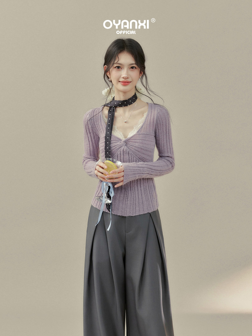 Model wearing a lilac knit top with wide-leg gray pants