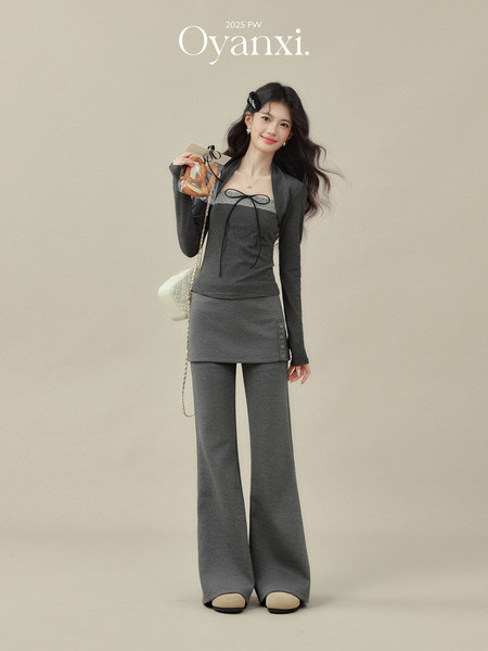 Model wearing a gray knit two-piece outfit with flared pants and a cropped top