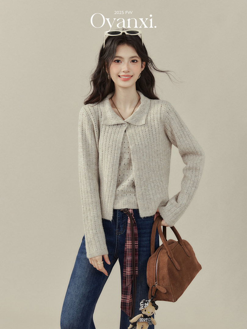 Model wearing a light knit cardigan with jeans and a brown handbag