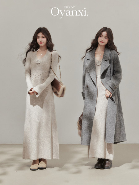Two women modeling a beige knit dress and a gray wool coat in a fall/winter fashion photo