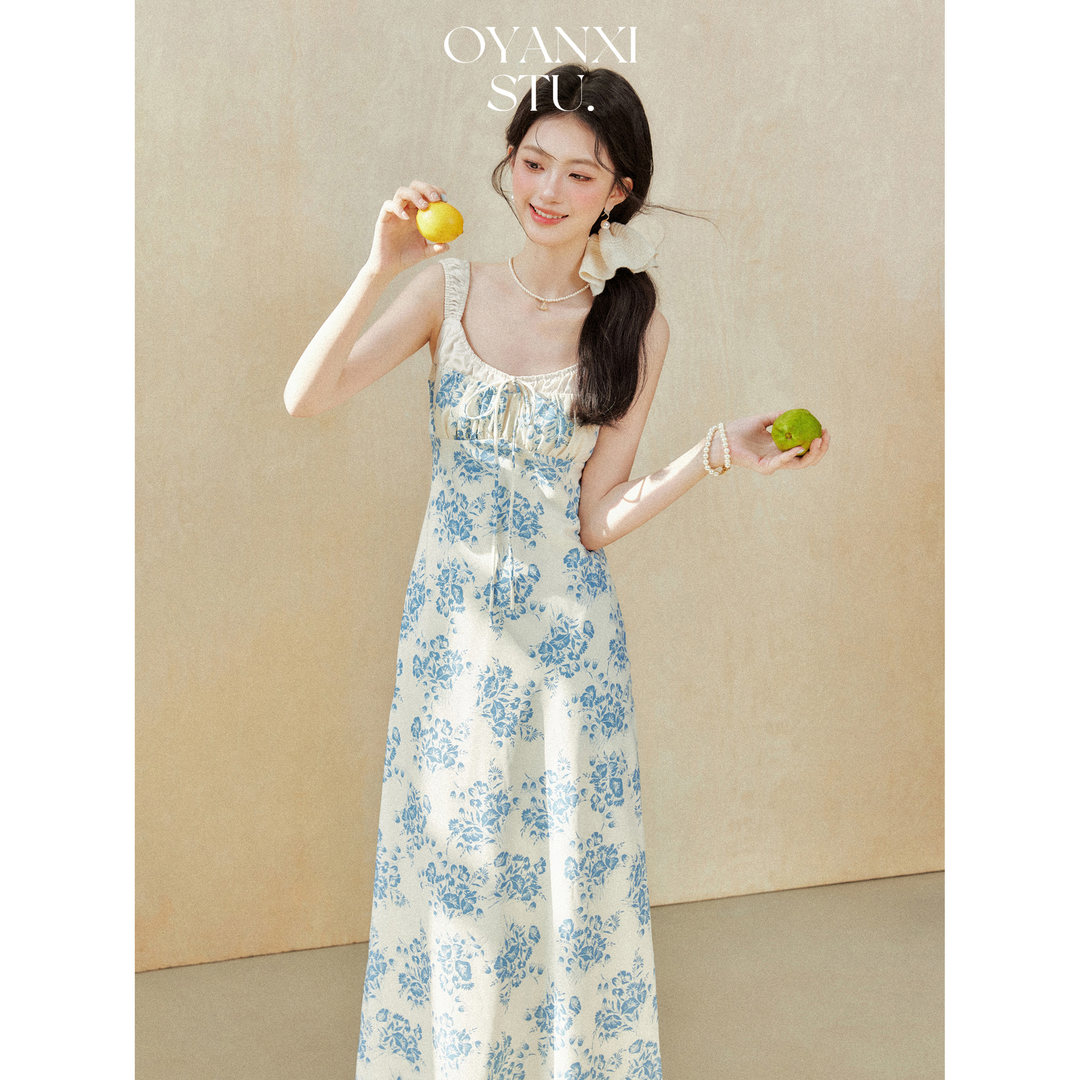 Woman wearing a blue floral sleeveless maxi dress