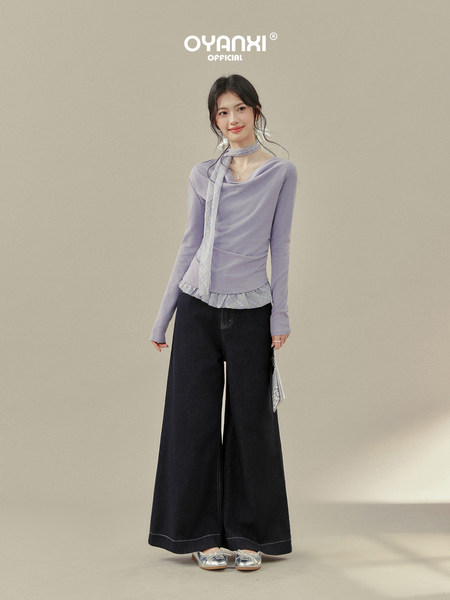 Model wearing a lavender long-sleeve top with black wide-leg pants and silver shoes