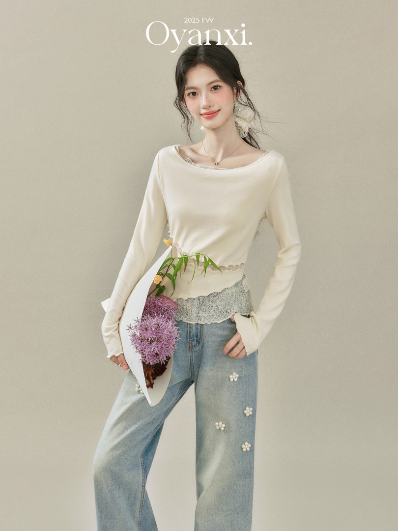 Model wearing a cream long-sleeve lace-trim top with embellished wide-leg jeans