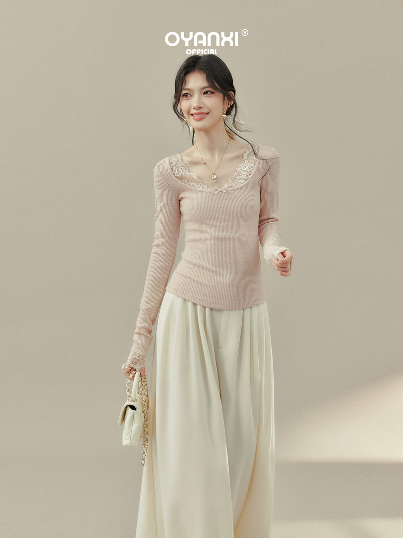 Model wearing a pink lace-trim long-sleeve ribbed top with a cream skirt