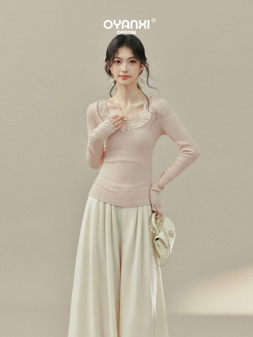 Model wearing a pale pink lace-trim ribbed top with a cream flowing bottom