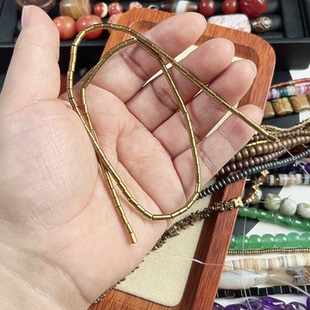 2.5mm*4mm金色黑胆石管珠一条40厘米长