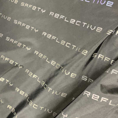 布彩印花布布料夜光幻彩面料面料炫七彩发光厂家直供反光字母反光