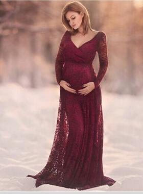 Evening gown with deep neckline and long sleeved lace