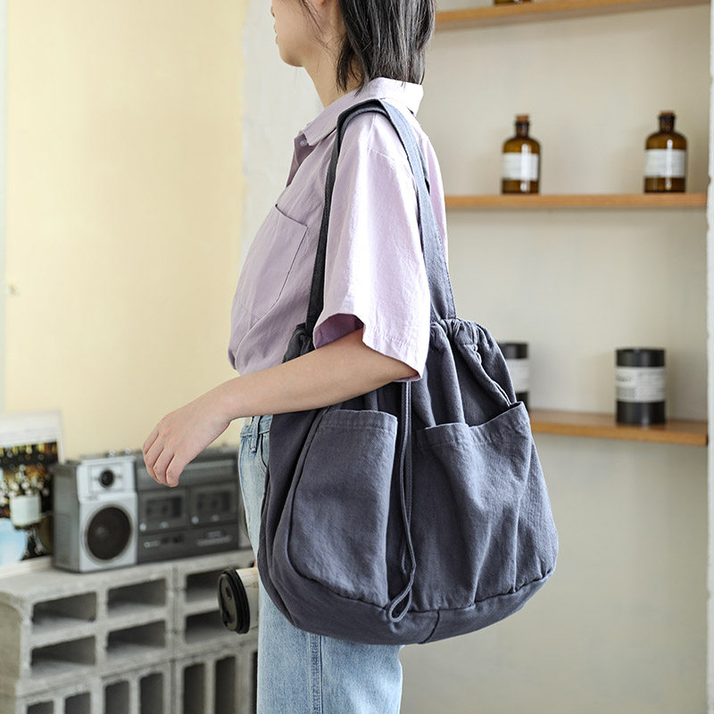 日系抽绳束口帆布包女简约百搭单肩帆布袋大容量学生手提布袋包