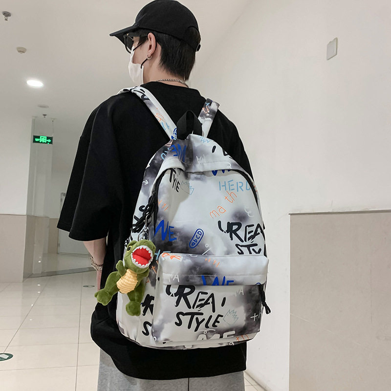 韩版男女书包潮流涂鸦中大小学生情侣双肩包便携百搭运动电脑背包