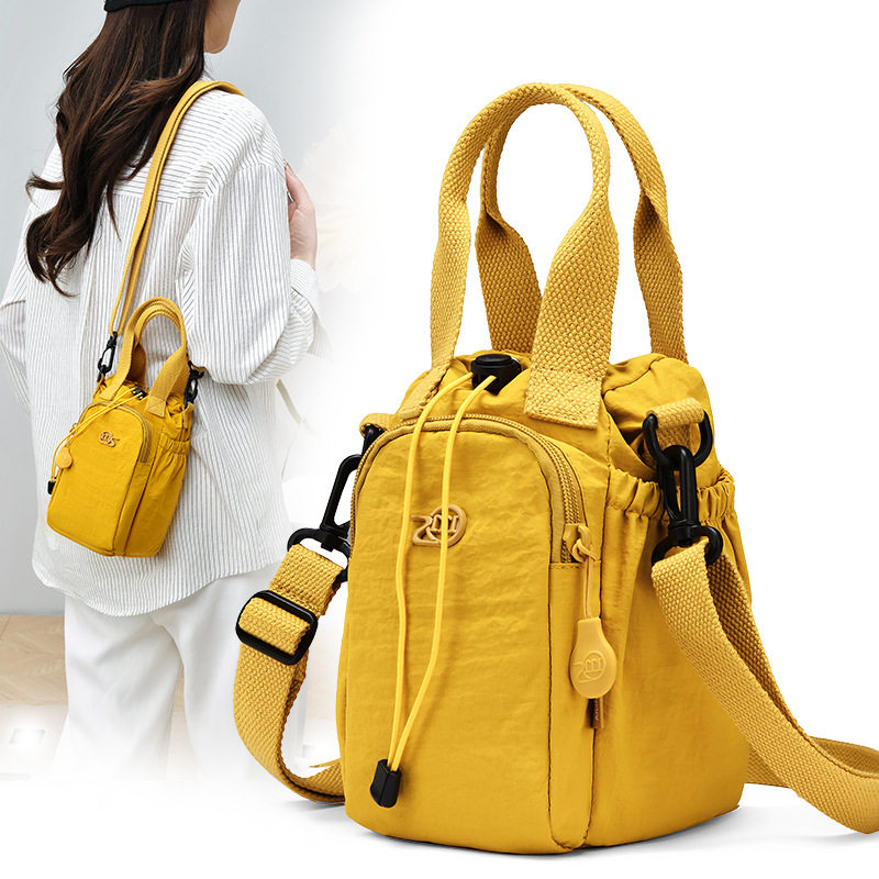 2026防泼水抽绳手机证件钥匙水杯位包6袋男女手提单肩斜挎水桶包