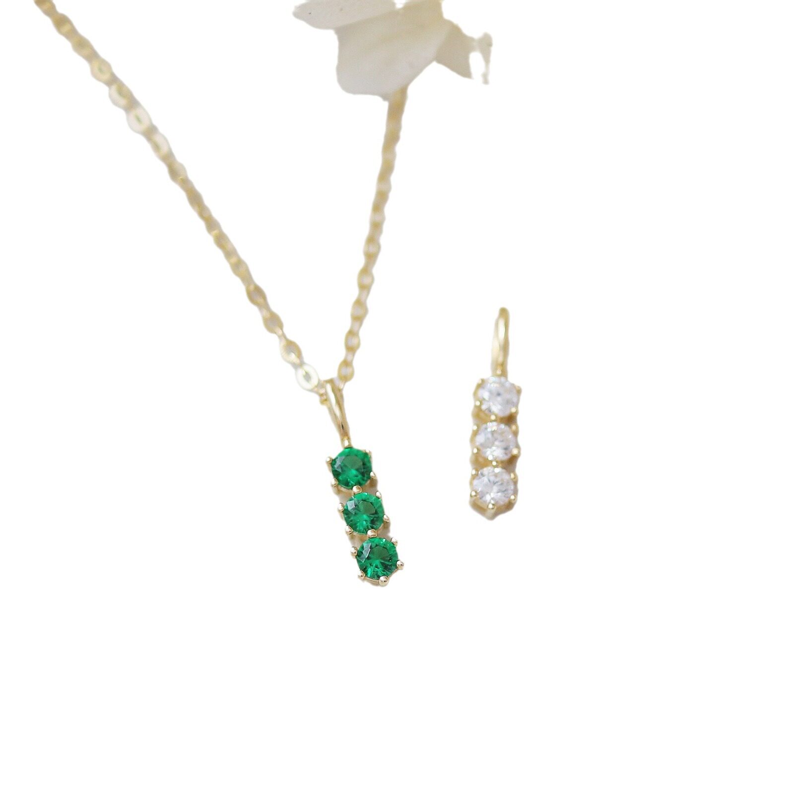 9k gold A small pendant with three diamonds in a single vertical bar