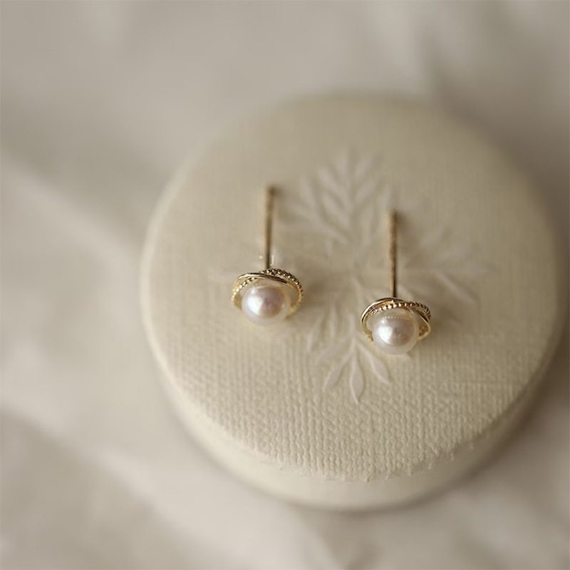 14K gold pearls surround the ear studs