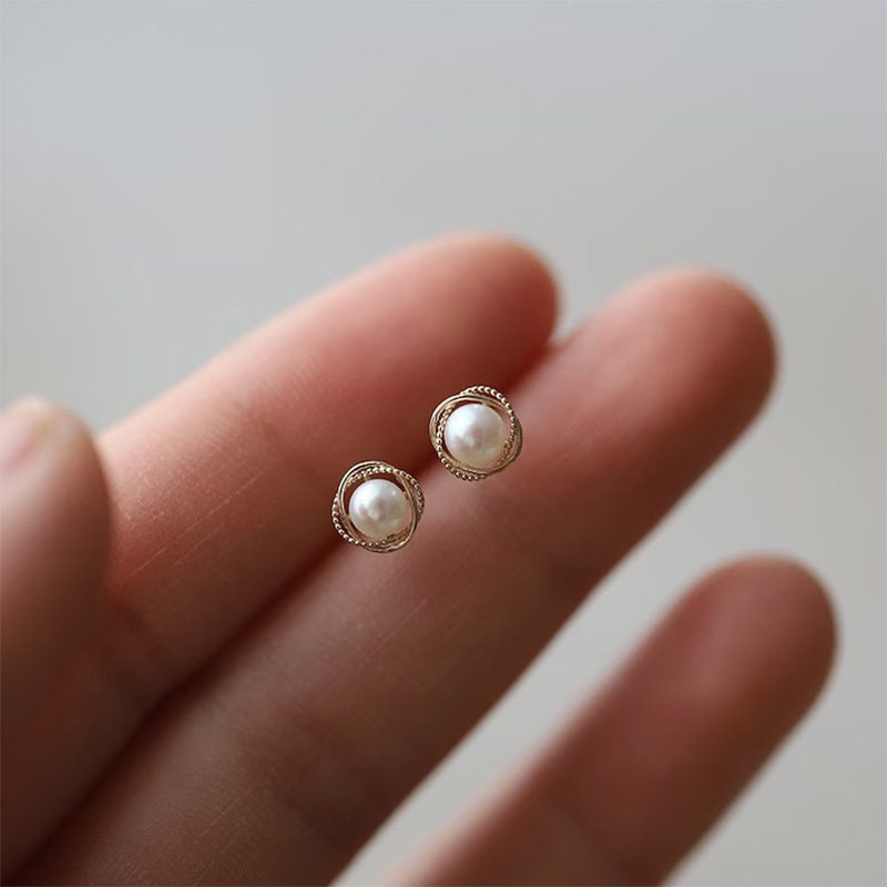 14K gold pearls surround the ear studs
