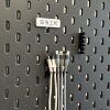 Cable organizer bracket adapts to IKEA perforated plate